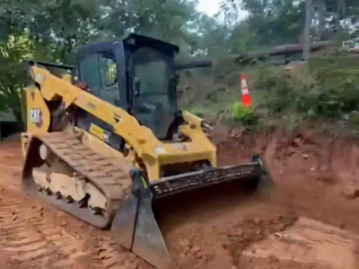 Our skid steer cutting grade across red clay