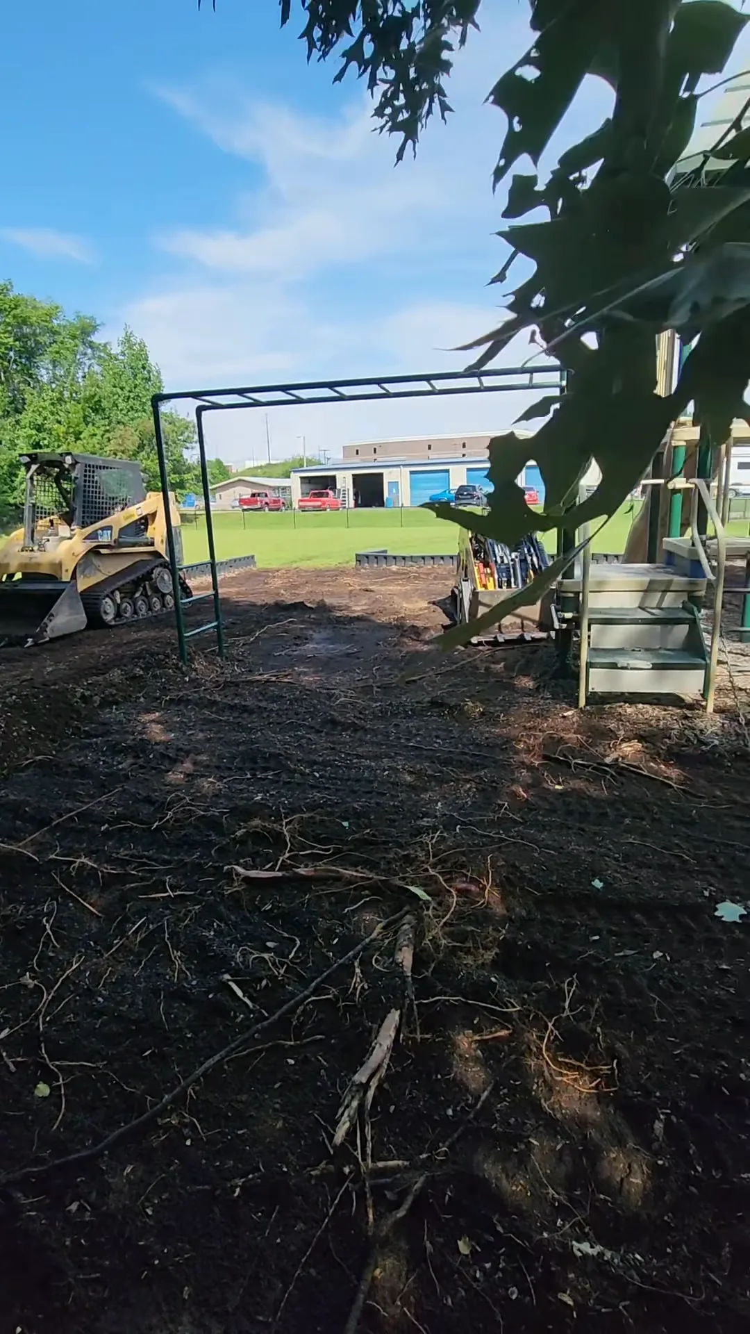 Spreading and grading mulch at a playground